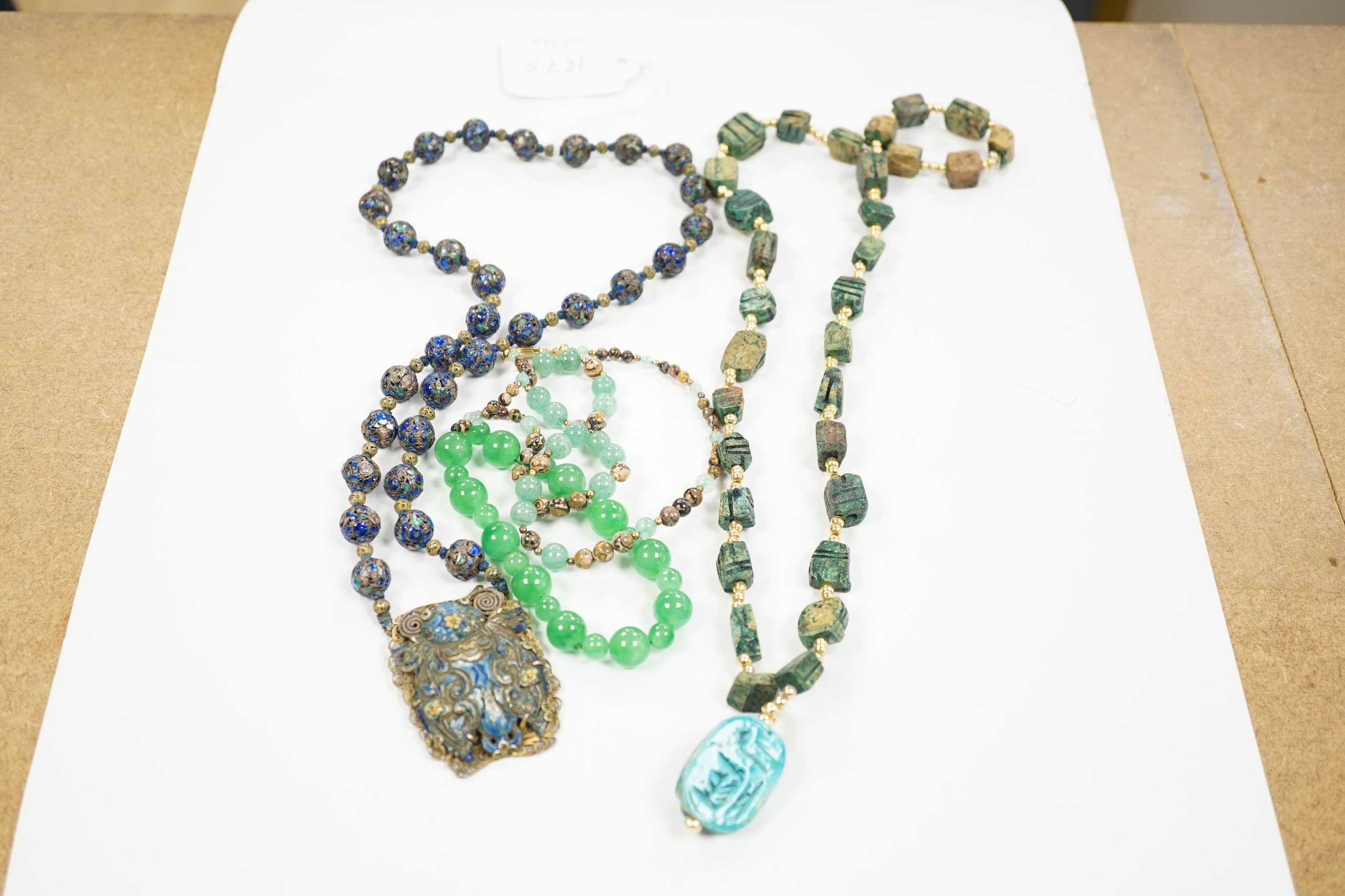Three assorted Chinese bead necklaces including filigree gilt white metal and enamel pendant necklace, overall 68cm and a jade bracelet.